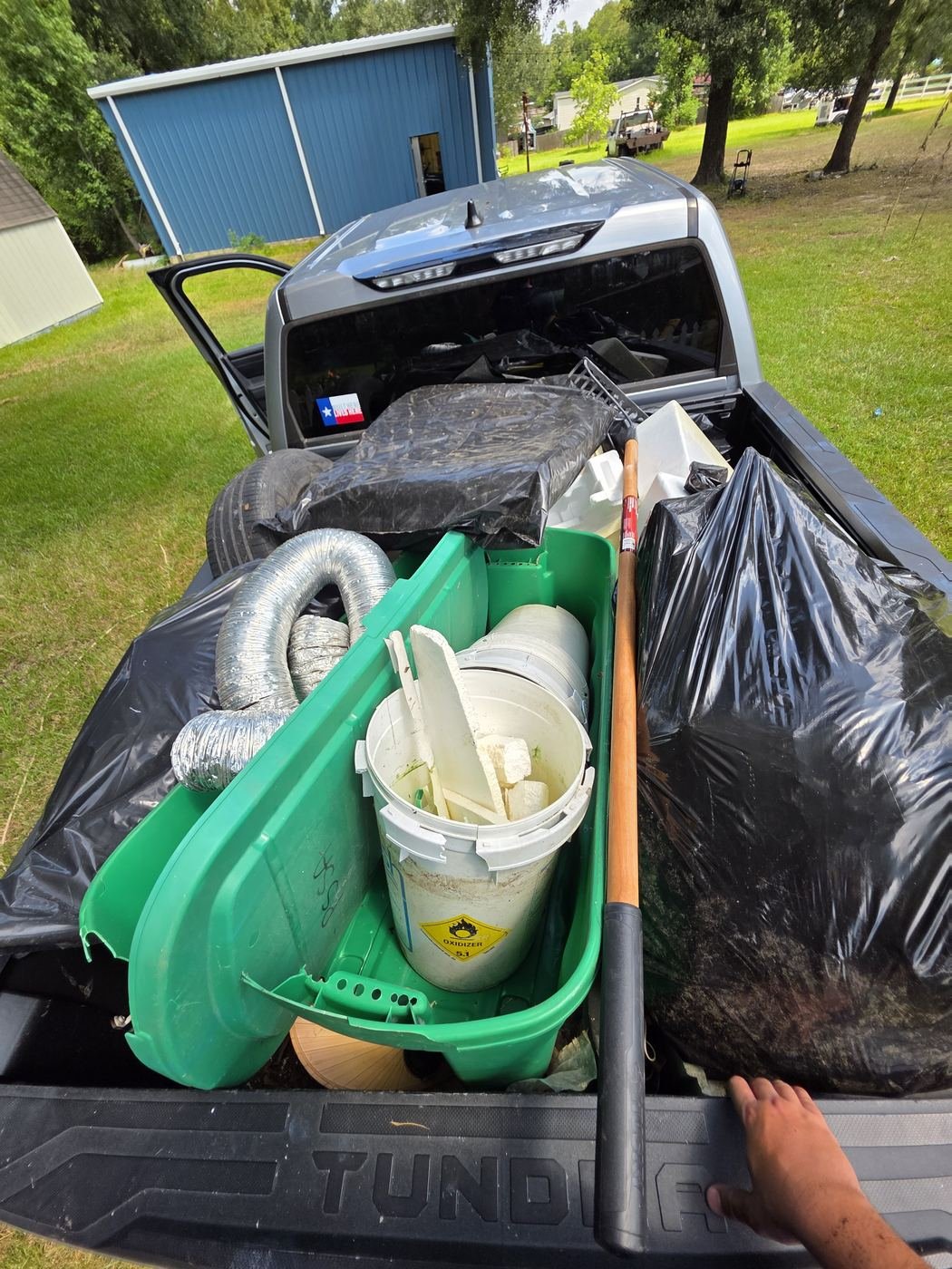 Truck bed loaded with junk items ready for haul-off
